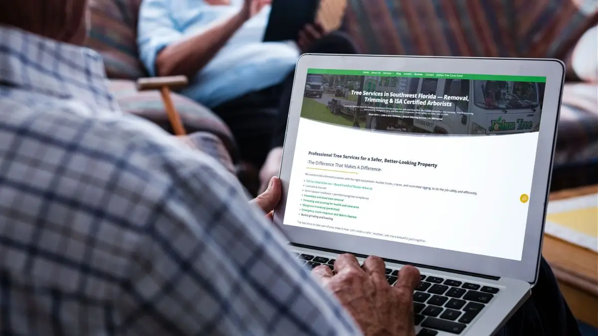 A customer viewing the redesigned Joshua Tree Inc. website on a laptop